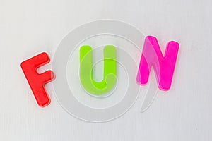 Colorful letters on white background. Kids plastic toy, learning alphabet and english words in language school. Text fun
