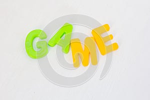 Colorful letters on white background. Kids plastic toy, learning english words in language school. Text game