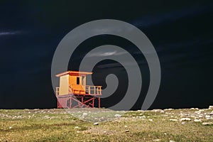 Colorful lifeguard tower on the coast at night