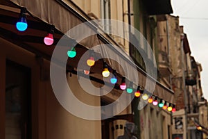 Colorful light bulbs. Abstract blurred background. Classic architecture details. Old facade with light bulb. Decorative