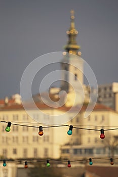 Colorful light bulbs with Belgrade panorama out of focus background