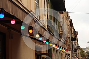 Colorful light bulbs. Classic architecture details. Old facade with light bulb. Decorative external lighting. Classic