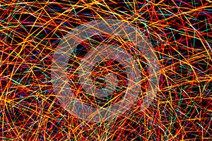 Colorful light painting abstract long exposure image with red, green, blue and yellow lines on a black background