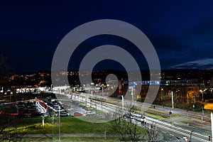 Colorful light stripes of cars on the street at night in front of a church in the city of plauen