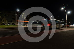 Colorful light trail with the motion blur effect of a bus