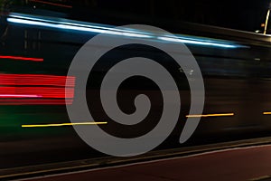 Colorful light trail with the motion blur effect of a bus