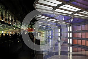 Colorful lighted walkway down a busy hall