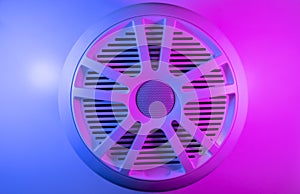 Colorful lights of car stereo and car speakers background. Car music audio speaker in blue and pink tones. Modern car audio syste