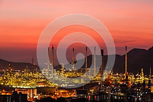 The colorful lights in oil refinery industry power station at night time with dark sky.