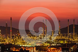 The colorful lights in oil refinery industry power station at night time with dark sky.