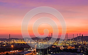 The colorful lights in oil refinery industry power station at night time with dark sky.