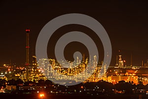 The colorful lights in oil refinery industry power station at night time with dark sky.