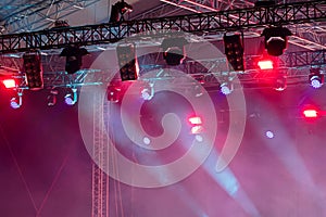 Colorful lights of projectors on outdoor concert stage