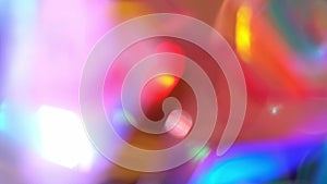 Colorful lights sparkle through shiny crystal and prism. Abstract blurry background, Lens flare