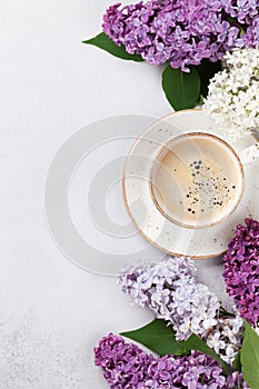 Colorful lilac flowers and coffee cup