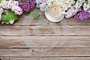 Colorful lilac flowers and coffee cup