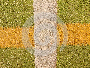 Colorful lines in empty outdoor handball playground, plastic light green surface on ground and white, red and blue bounds lines.