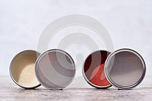 colorful lip balms in round tin cases , mockup design