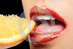 Colorful lips eating lemon