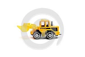 Colorful little mini yellow plastic tractor, truck, lorry, car toy isolated on white background mockup with copy space