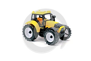 Colorful little mini yellow plastic tractor, truck, lorry, car toy isolated on white background mockup with copy space