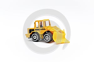 Colorful little mini yellow plastic tractor, truck, lorry, car toy isolated on white background mockup with copy space