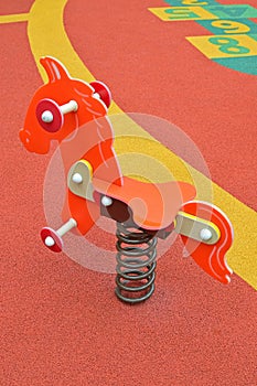 Colorful little pony spring rider in children playground
