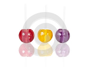 Colorful loll pop candies on white with reflection