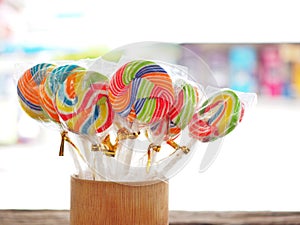 Colorful lollipop on the wooden board in the children`s fun concept