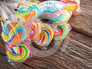 Colorful lollipop on the wooden board in the children`s fun concept