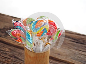 Colorful lollipop on the wooden board in the children`s fun concept