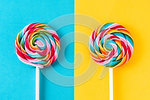 Colorful lollipops on blue and yellow background.