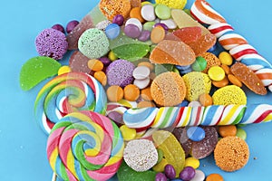 Colorful lollipops and different colored round candy.