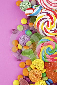 Colorful lollipops and different colored round candy.