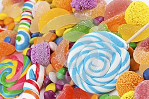 Colorful lollipops and different colored round candy.