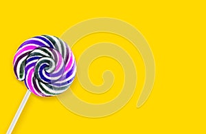 Colorful lollipops on yellow background