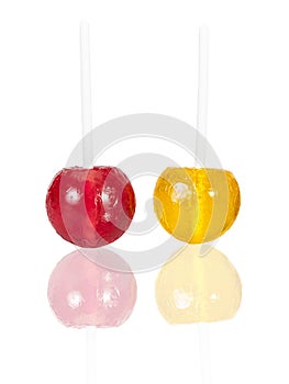 Colorful lolly pop candies on white with reflection