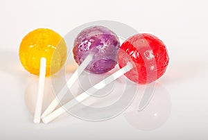 Colorful lolly pops on white