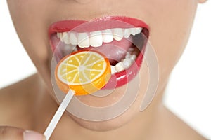 Colorful Lollypop in perfect woman teeth