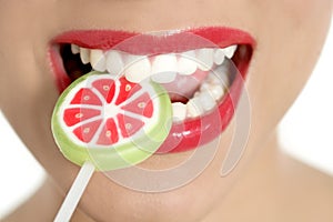 Colorful Lollypop in perfect woman teeth