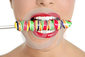 Colorful Lollypop in perfect woman teeth