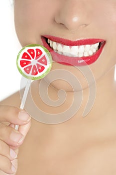 Colorful Lollypop in perfect woman teeth