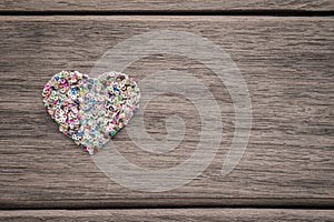 Colorful love heart on wood background with space for text