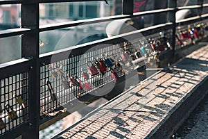 Colorful love locks on the bridge on a sunny day