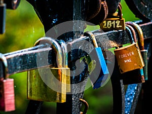 Colorful love locks hanged on bridge.