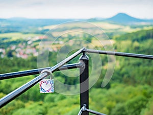 Colorful love padlock locked on bridge bar. Symbol of marriage or eternal love