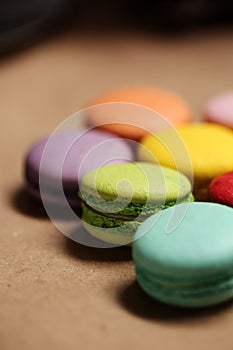 Colorful macarons cake. Closeup macaroons on color white isolated background. in coffee shop vintage color. Wooden table