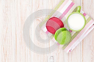 Colorful macarons and cup of milk