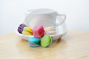 Colorful macarons and milk cup