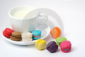 Colorful macarons and milk cup